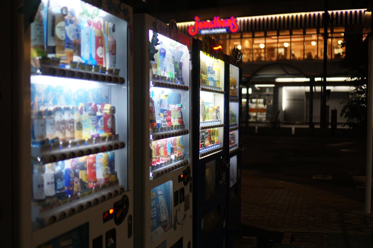 Illuminated vending machines on a Tokyo street at night. Captures urban nightlife vibes.